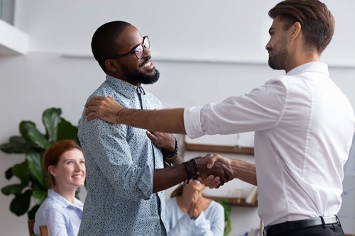 The person plural is receiving a handshake after bring able to thrive at the company.