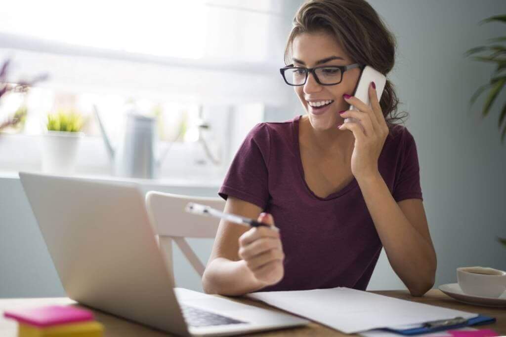 woman on phone at desk