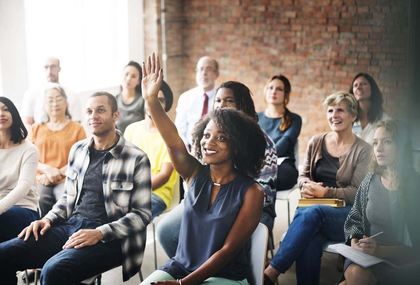 Woman raising hand at event