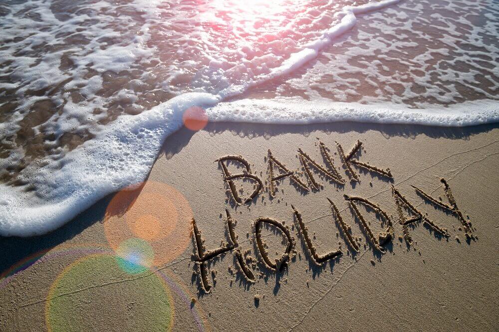 bank holiday written in the sand