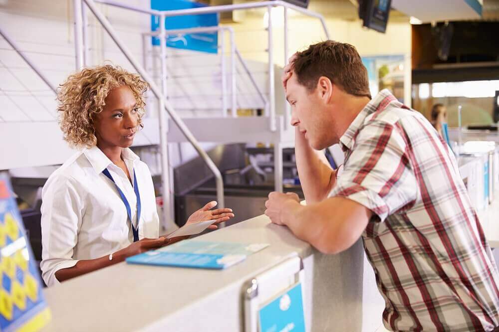 Man distressed at check in desk
