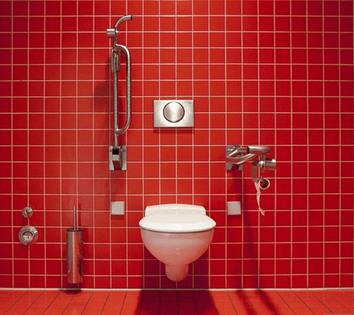 a red bathroom with toilet facilities