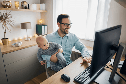 Man working on with child on lap