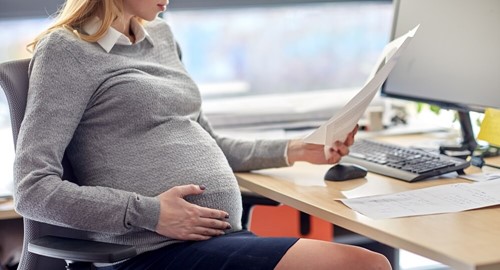 pregnant employee checks her employment responsibilities