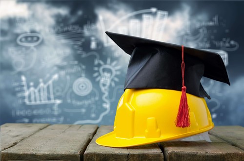 a hard hat and a degree apprenticeships hat after a work placement success and full time education.