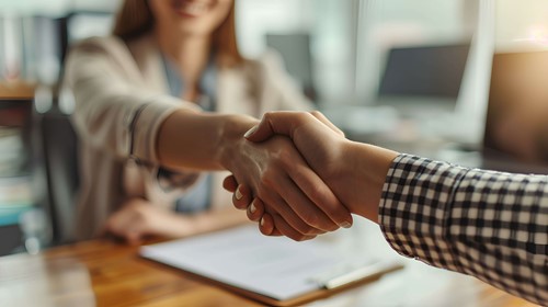 an employee relations being fixed by shaking hands after a settlement agreements