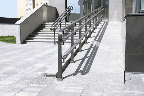 reasonable adjustments in the form of a ramp for a disabled person next to stairs for disabled people