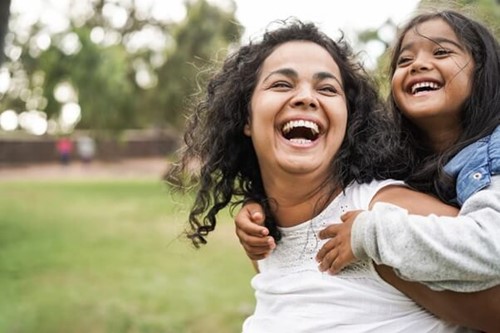 Mother and daughter enjoying family time with access to referral services to childcare.