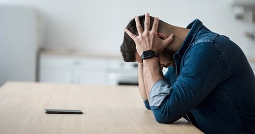 Photo of an office worker showing the signs of stress.