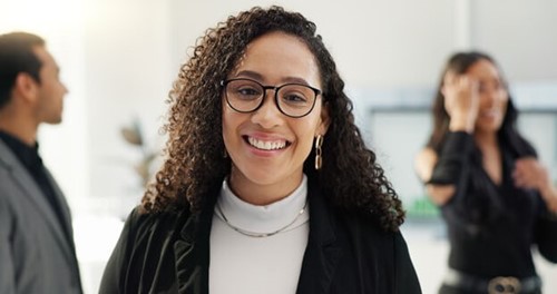 Happy female employee with access to mental health services at work.