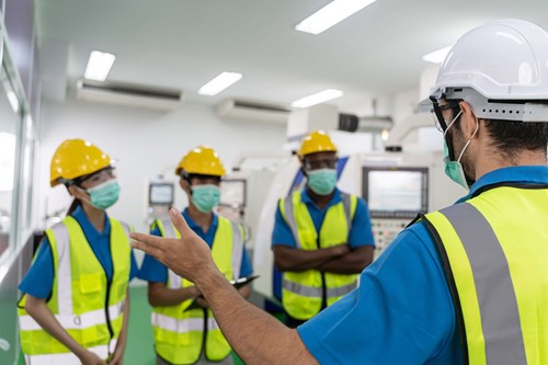 Health and safety information being delivered in safety training employees by a safety representative.