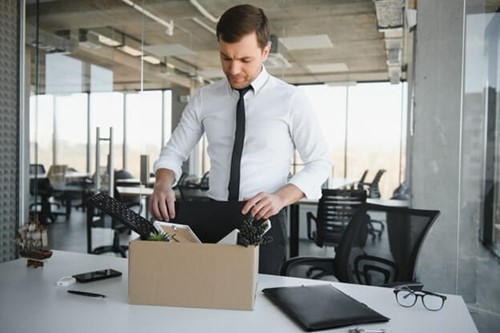 an employee packing up their box of belongings.