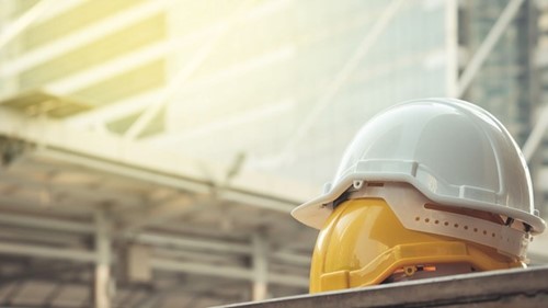 Image of a hard hat on a construction site in line with safety and welfare regulations