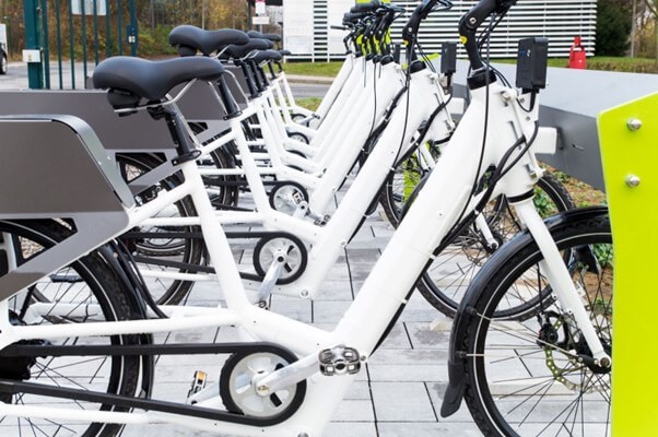 A row of bicycles parked on a sidewalk