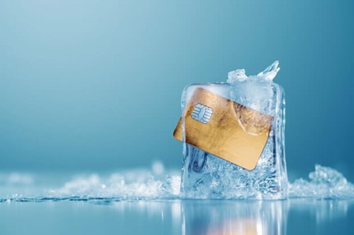 picture of a frozen credit card, indicating a freeze in job training and pay due to company cutbacks to avoid job losses.