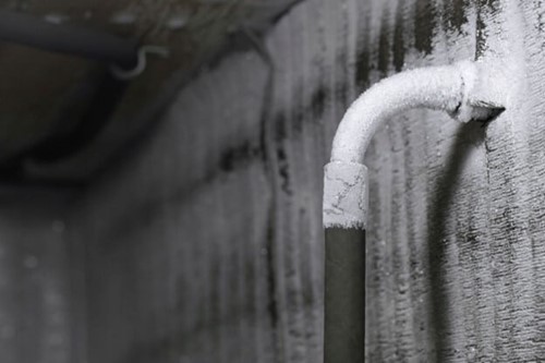 A frozen pipe due the extreme wintery conditions, representing a hazard in the workplace