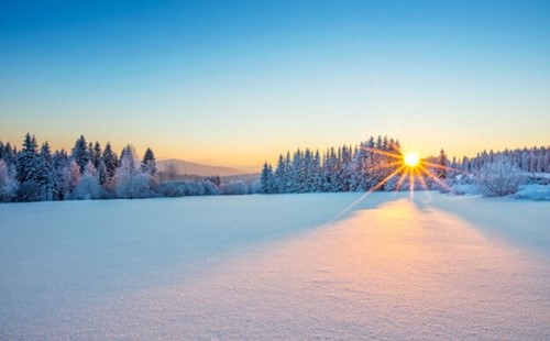 A snow covered landscape showing wintery conditions.