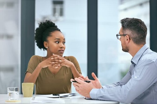 an employee who has taken frequent toilet breaks due to health conditions speaking to their employer.