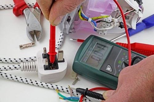 An electrical engineer PAT testing an appliance.