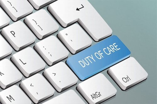 Picture of a keyboard with the words duty of care written on one of the keys as a reference to employers Duty of Care.