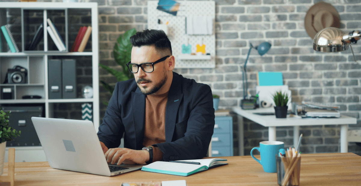 office worker squinting whilst trying to read on laptop