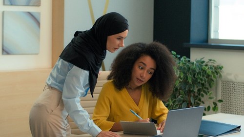 a religious employee discussing a work project with a colleague.