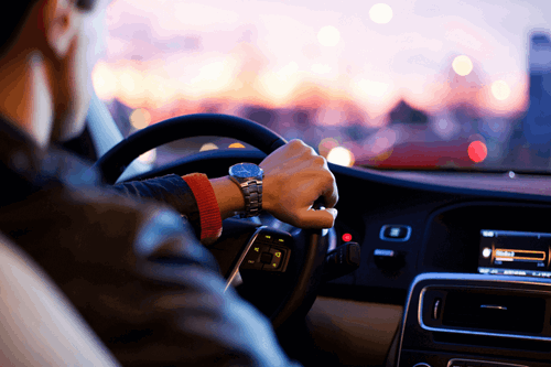 man siting in car with patek
