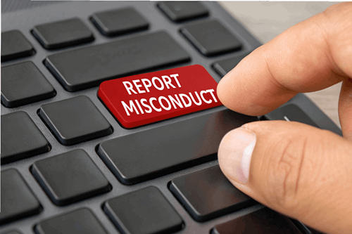 keyboard with the words 'report misconduct'