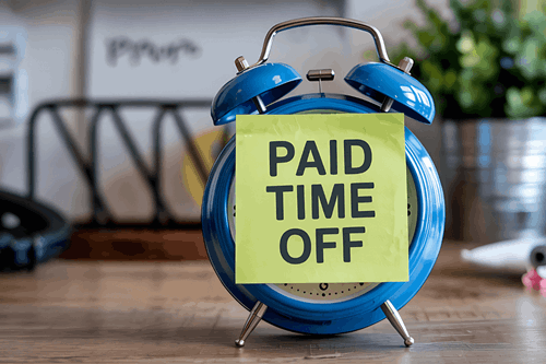 clock with note on its front saying paid time off