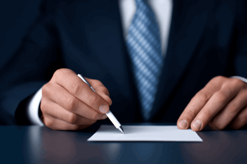 manager writing disciplinary action letter with fancy pen