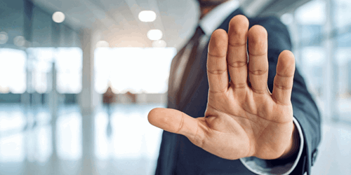 man gesturing 'stop'