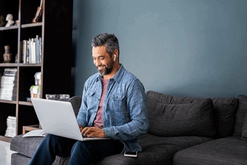 a male employee using their display screen equipment and electrical equipment while home working