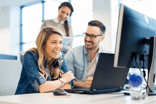 a line manager and employee using display screen equipment while in a positive office environment.