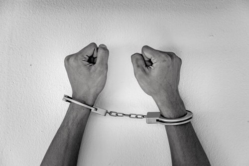 A pair of hands in handcuffs
